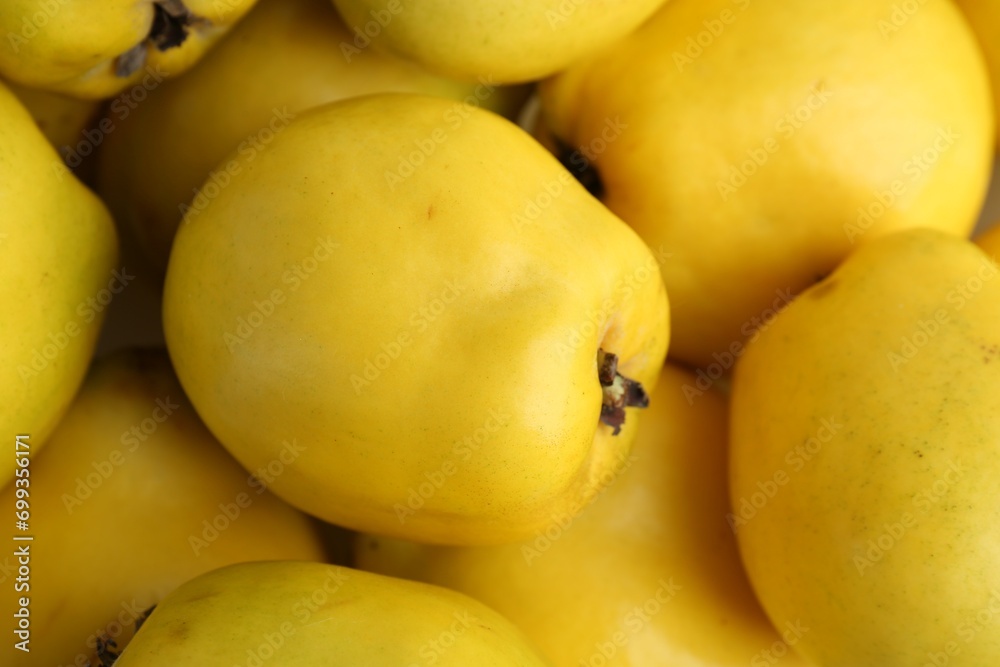 Delicious ripe quinces as background, closeup view