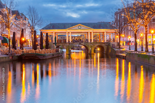 Night Leiden canal Oude Rijn and bridge Koornbrug in Christmas illumination, Holland, Netherlands. photo
