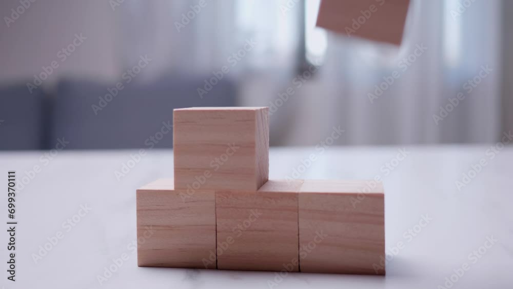 Growth reduction process concept - Detail of hand removing blocks from pyramid Growth reduction process concept - Detail of hand removing blocks from pyramid