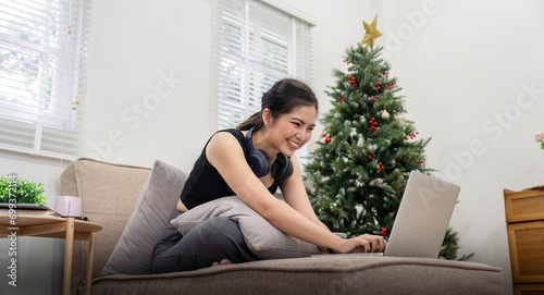 Young cheery happy positive cute beautiful business woman sit indoor in home using laptop computer