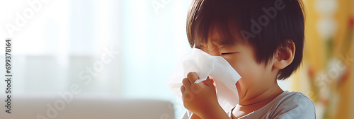 Child sniffing nose with tissue