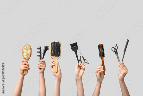 Many female hands with hair supplies on white background. photo