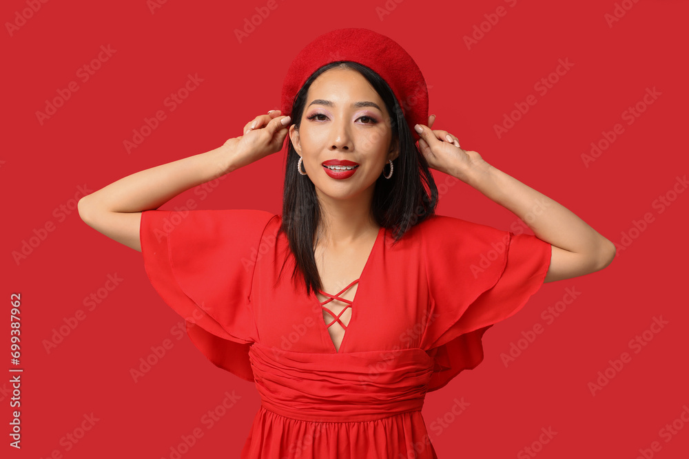 Beautiful Asian woman with stylish makeup on red background Beautiful Asian woman with stylish makeup on red background