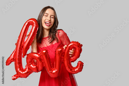 Happy young woman in red dr...