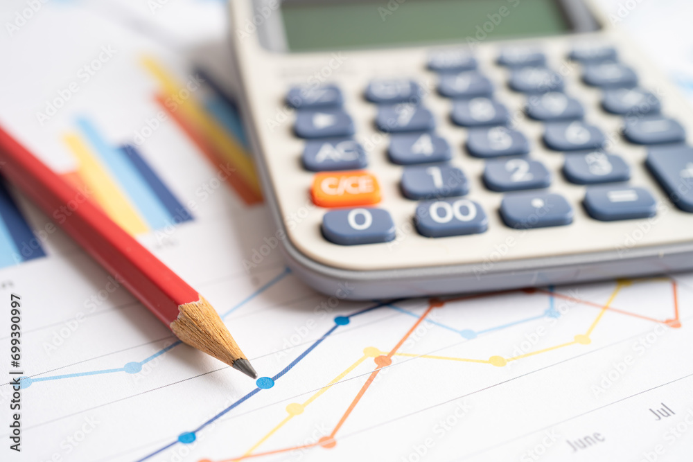 Pencil and calculator on chart or graph paper. Financial, account, statistics and business data concept. Pencil and calculator on chart or graph paper. Financial, account, statistics and business data concept.