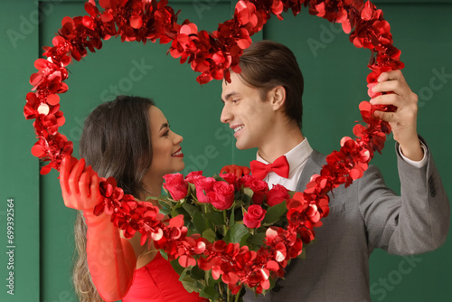 Young couple with roses and...