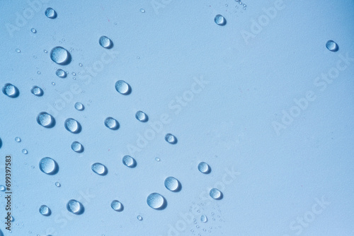Blue transparent water drops, cosmetic texture. Moisturising cosmetics concept, spa texture. Skincare spray