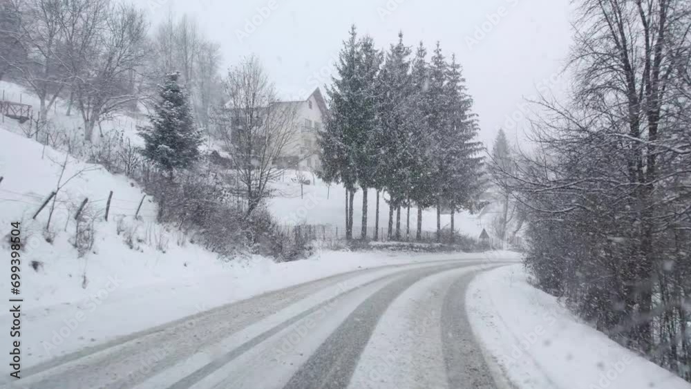Driving in forest on curvy road with heavy snow fall storm Driving in forest on curvy road with heavy snow fall storm