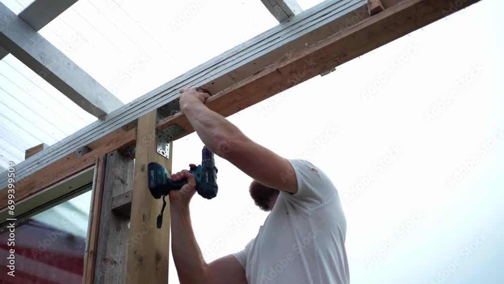 A Man is Building the Framework for a Greenhouse in Indre Fosen, Trondelag County, Norway - Close Up A Man is Building the Framework for a Greenhouse in Indre Fosen, Trondelag County, Norway - Close Up