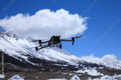 Fototapeta Naklejka Na Ścianę i Meble -  Flying drone in high altitude mountains