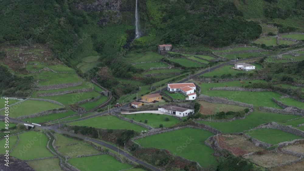 Wide view of cascata do poco do bacalhau waterfall at Fajã Grande - Drone shot