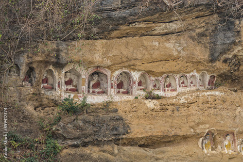 Serene Buddha statues carved in Akauk Taung cliff, Pyay photo