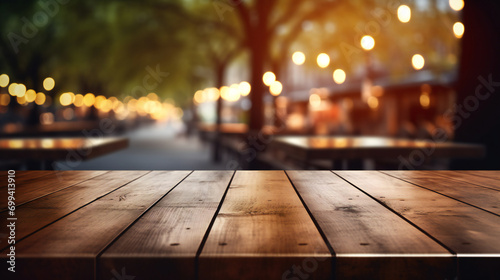 Empty wooden table on blurred outdoor food court background