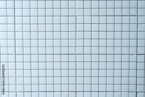 White concrete tile wall in square ceramic pattern. White tiles wall texture