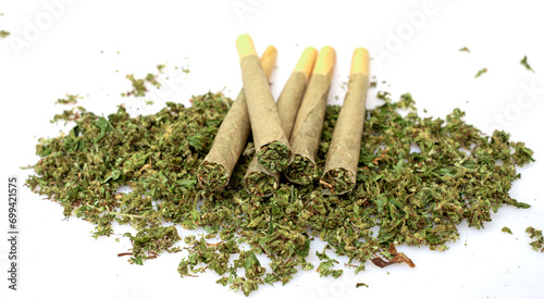 Pre-Roll marijuana joint with cannabis buds in a clear glass jar on the white background