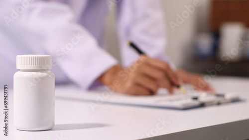 Initial AI illustration of a close-up of a female doctor's hand signing a medical document on a clipboard. and recommending certain medicines to patients on a laptop © Worapon