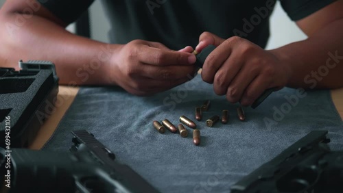 Care and maintenance Bullet reloading and cleaning by an Asian man Disassembly of a firearm for cleaning and handheld gun safety inspection. Gun assembly. Weapon care. High quality 4k images. photo
