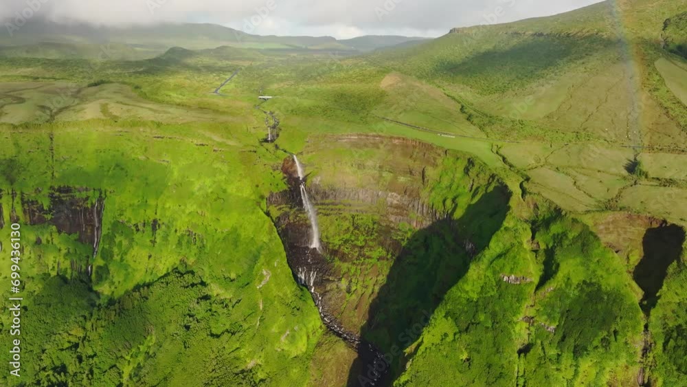 Tilt up shot of big rainbow at Cascata da Ribeira Grande, Azores islands