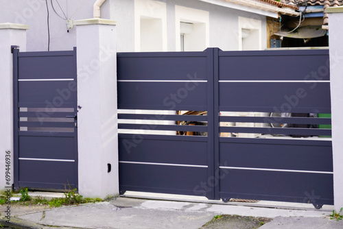 door modern steel aluminum grey gate portal and pedestrian door of suburb house facade photo