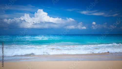 tropical beach scene  azure ocean  sunny sky  and sandy shore  evoking relaxation and serenity