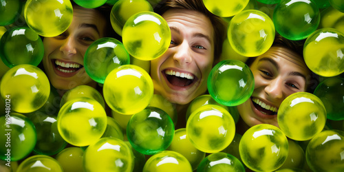 A playful scene of a man and a woman surrounded by plastic balls in a ball pit, featuring Julian Ope, creating a fun and vibrant atmosphere