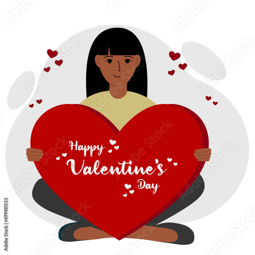 A woman holds a big red heart with congratulations on Valentine's Day.