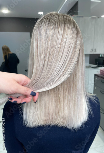 Blond hair dyeing in air touch or shatush technique. Look from behind photo