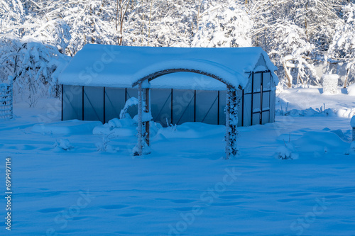 Greenhouse covered in snow a cold winters day photo