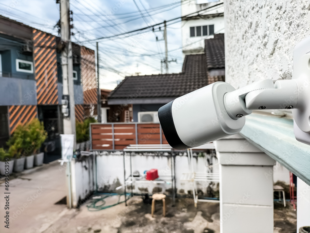 Installing CCTV cameras outside buildings and houses by attaching them to the wall.