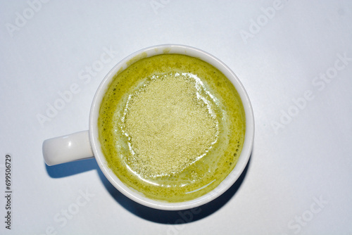 Close up of a glass of milky matcha drink