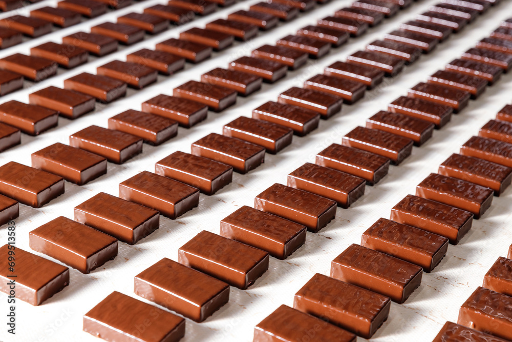 Closeup set Chocolate sweets candy on conveyor automatic line factory, top view
