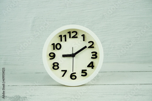 white clock on wooden background