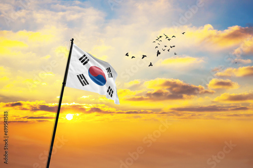 Silhouette of a soldier with the South Korea flag stands against the background of a sunset or sunrise. Concept of national holidays. Commemoration Day. photo