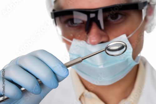 dentist a man in a white coat wearing glasses and a mask, a man in gloves holding a small mirror in his hands