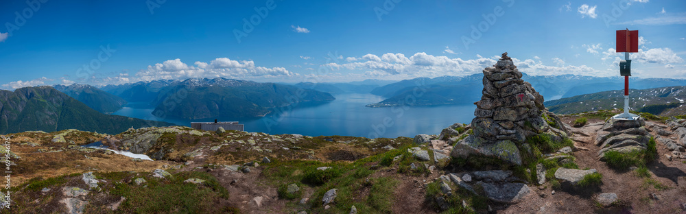 A panorama view from the summit of Raudmelen peak overlooking the town of Balestrand, Norway and Sognefjorden during a summer morning. A panorama view from the summit of Raudmelen peak overlooking the town of Balestrand, Norway and Sognefjorden during a summer morning.