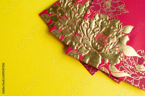 Fototapeta Naklejka Na Ścianę i Meble -  Chinese New Year red packets on yellow cover background with customizable space for text