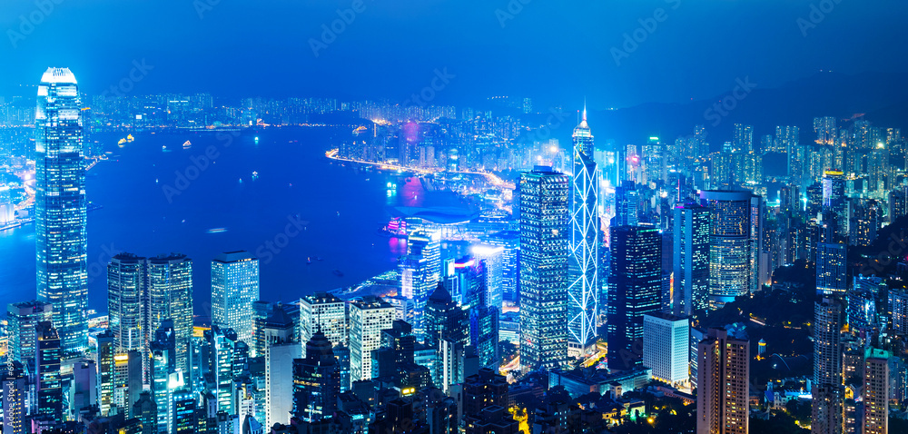 Hong Kong cityscape with victoria harbour and large group of tall buildings at night - obrazy, fototapety, plakaty 