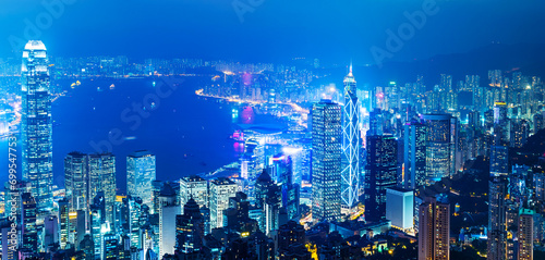 Hong Kong cityscape with victoria harbour and large group of tall buildings at night photo