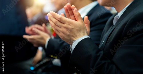 Foto Group of business people clapping in a row