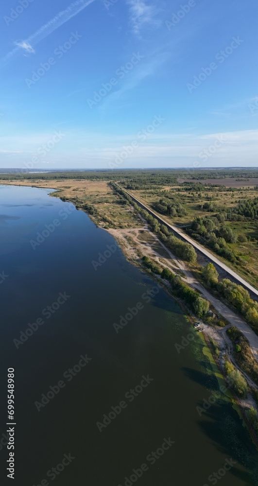 Obraz premium The river bank goes beyond the horizon on the Sura River.