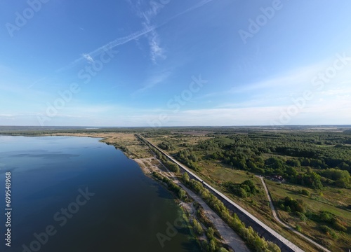 Wallpaper Mural Landscapes in Russia from a bird's eye view; the water surface borders the shore on which there is a concrete road Torontodigital.ca