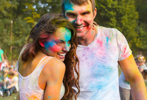 Happy couple in love on holi color festival
