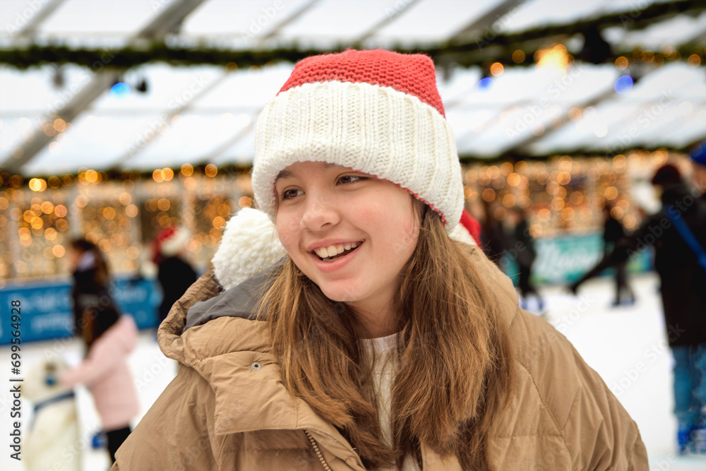 Fun on a winter Christmas skating rink, Portrait of a 11-13 year old girl skating Fun on a winter Christmas skating rink, Portrait of a 11-13 year old girl skating