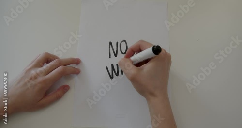 a person writes on paper no war. High quality 4k footage photo