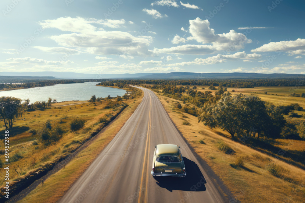 Vintage green car rides an empty highway on a summer day, rear bird eye view