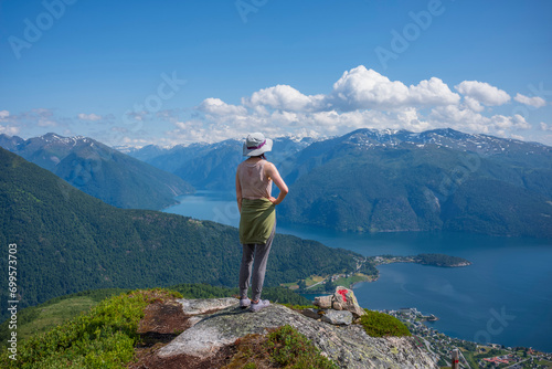 Hikers climb to the summit of Raudmelen peak which overlookis the town of Balestrand on Sognefjord during a summer morning. © Jonathan W. Cohen 