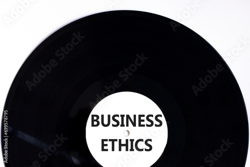 Business ethics symbol. Concept words Business ethics on beautiful black vinyl disk. Beautiful white table white background. Business ethics concept. Copy space.