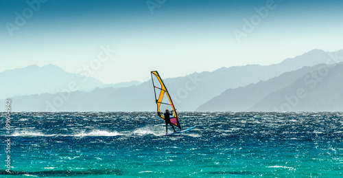 windsurfer rides on a background of high mountains in Egypt Dahab South Sinai photo