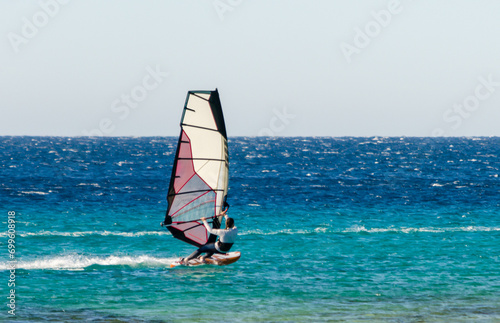 young surfer girl rides a sail in the Red Sea in Egypt Dahab © Sofiia