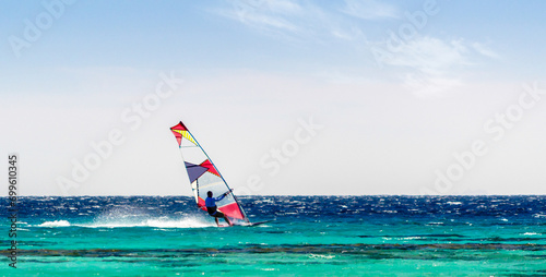 surfer rides in the Red Sea on the background of a clear sky in Egypt Sharm El Sheikh